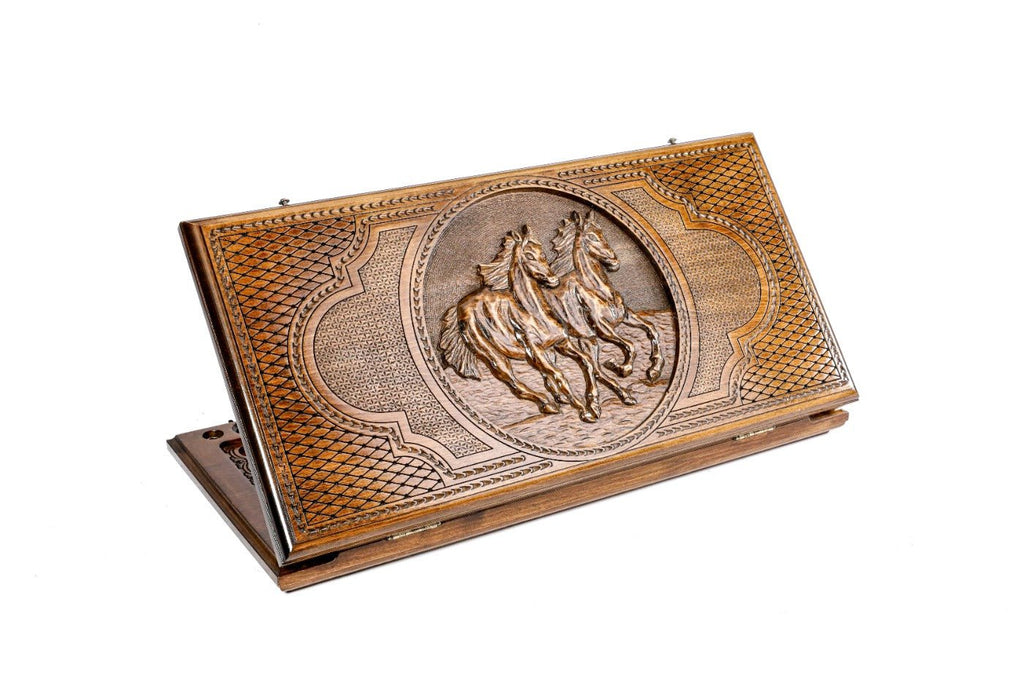 A frontal shot of the closed Horse classic backgammon board by Hrachya Ohanyan showing the detailed high-relief horse carving.