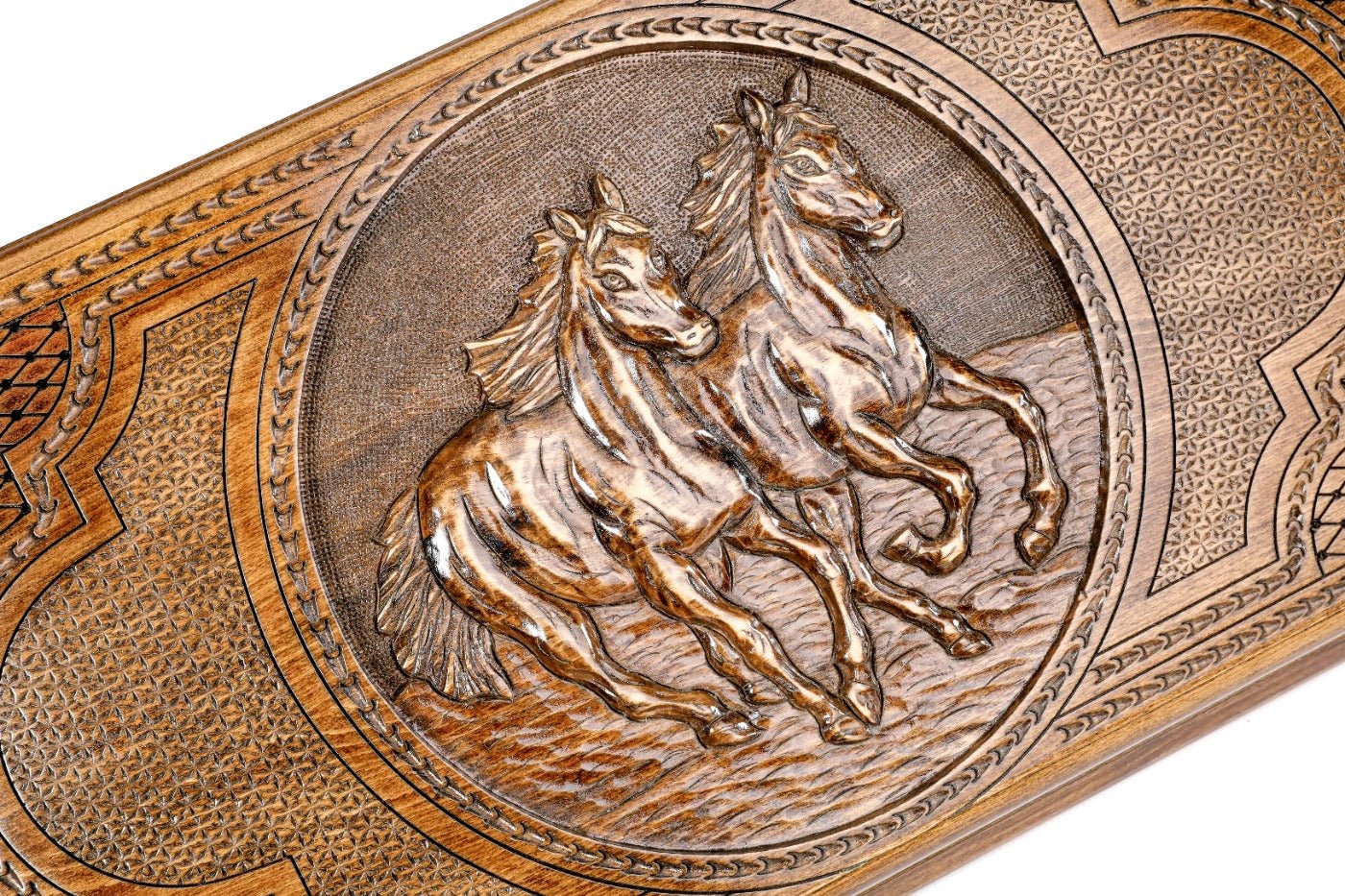 The interior of the open wooden backgammon board highlighting the smooth, polished playing field and pips.