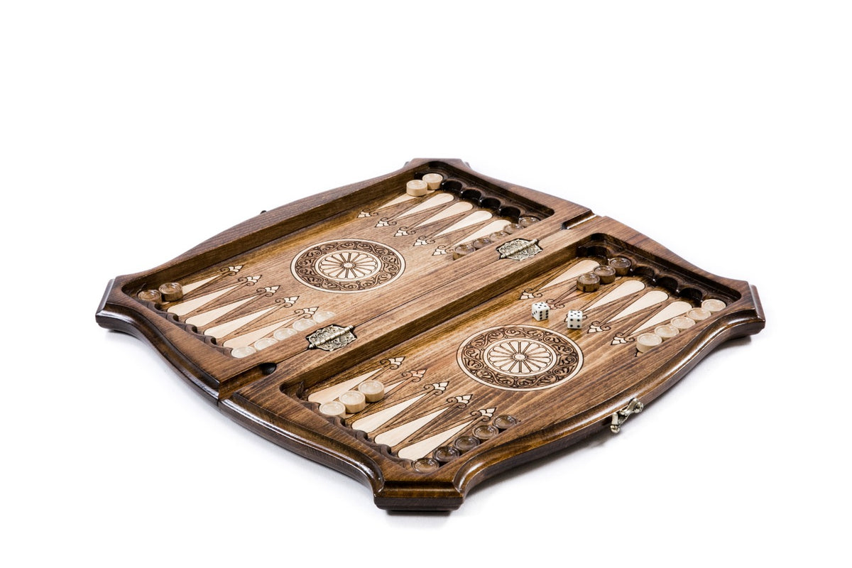 Ararat chess and backgammon set opened to the carved backgammon field with wheel ornaments and checkers
