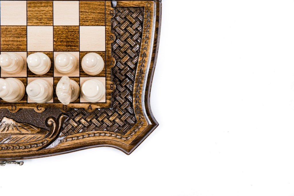 Corner detail of the carved braid ornament, carved letters and light chess pieces with Ararat below