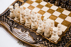 Close-up of Mount Ararat carved in relief on the frame beside the light hand-carved chess pieces