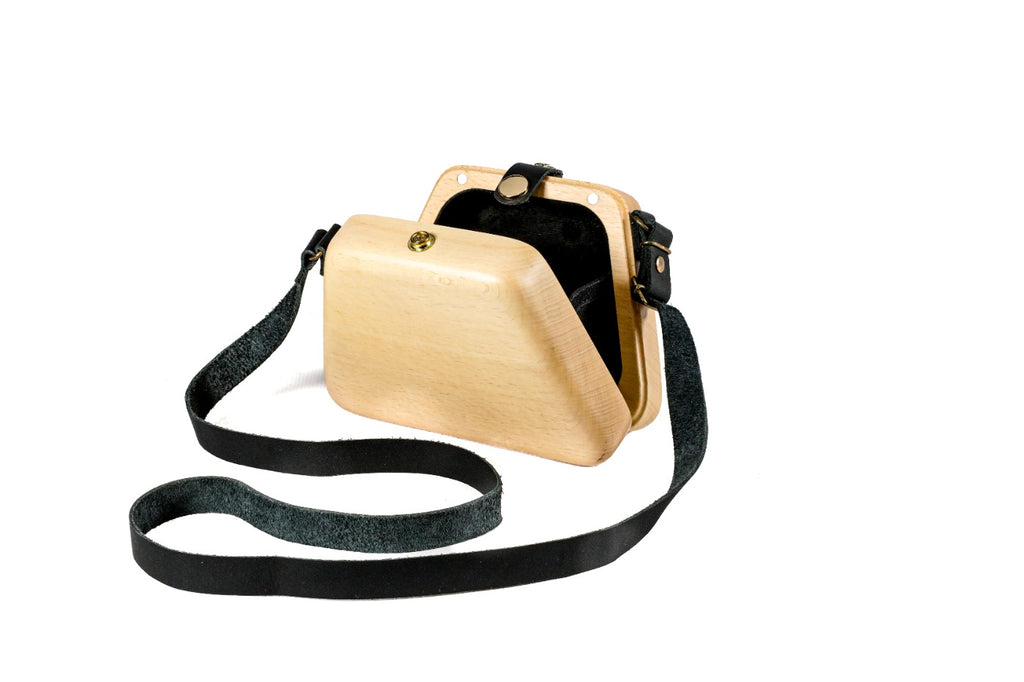 Natural wooden bag with black leather strap — side view