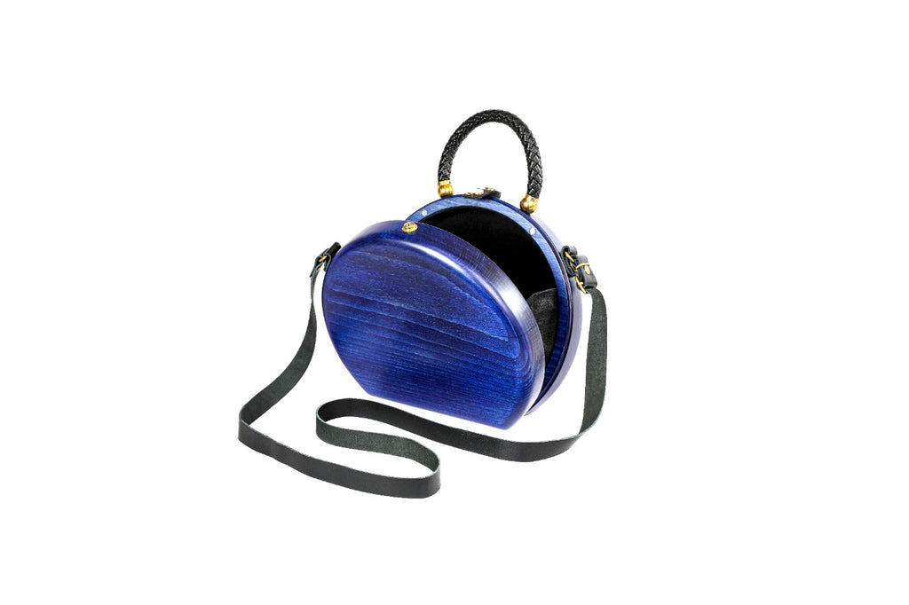 Round wooden bag in royal blue — angle view