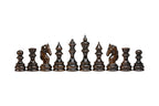 The dark walnut side of the set: pawns, rooks, carved horse-head knights, bishops, queen and king