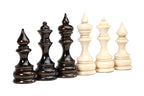 Close-up of the walnut bishop, queen and king beside the beech king, queen and bishop, velvet bases