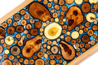 An angled view of the Hrachya Ohanyan board highlighting the glossy finish and the natural growth rings of the wood.