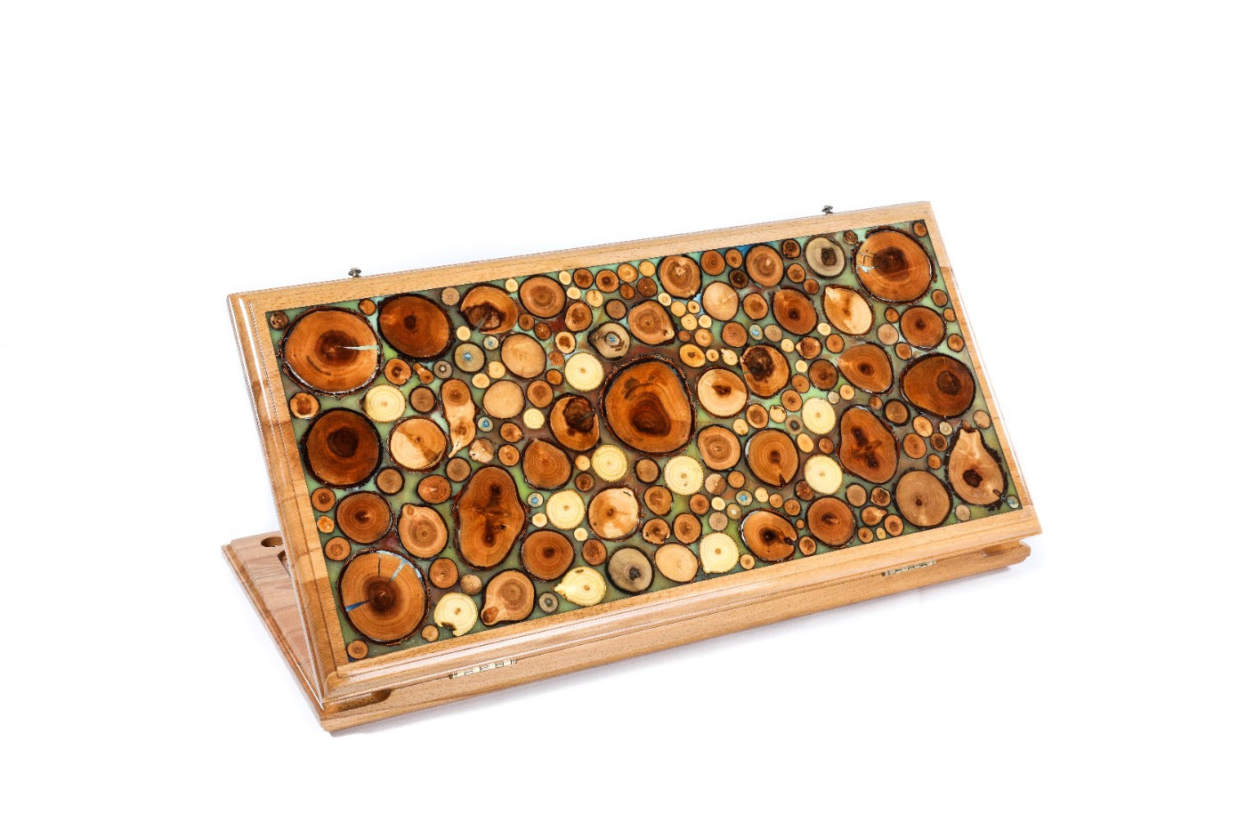 Closed turquoise epoxy backgammon board with visible tree branch slices and high-gloss finish.