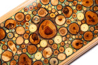 Close-up of the translucent turquoise resin and natural wood grain on the Hrachya Ohanyan board.