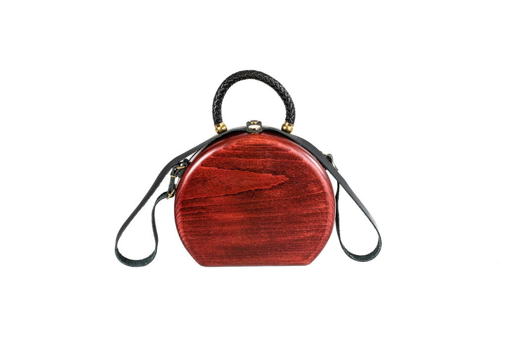 Round wooden bag in cherry red — angle view