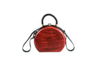 Round wooden bag in cherry red — angle view