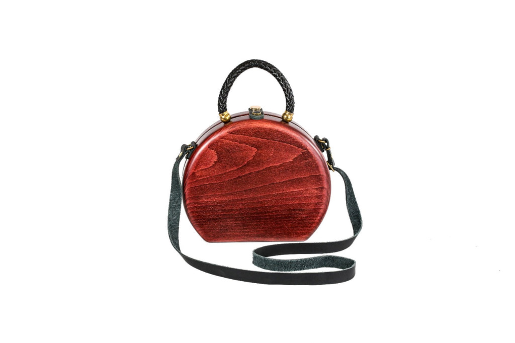 Round wooden handbag in cherry red — detail view