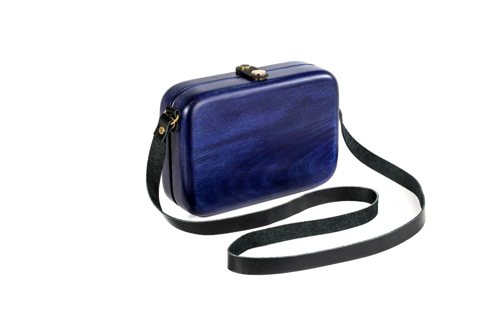 Indigo blue wooden bag with leather strap — side view
