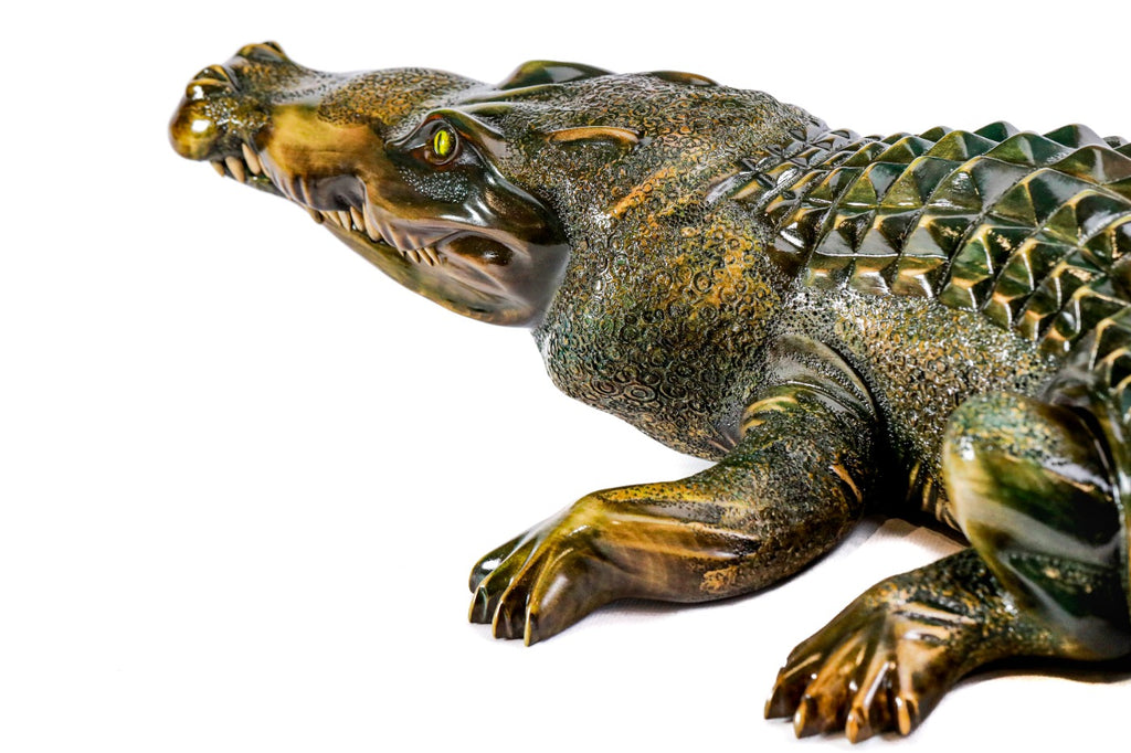 Hand-carved crocodile sculpture — profile view