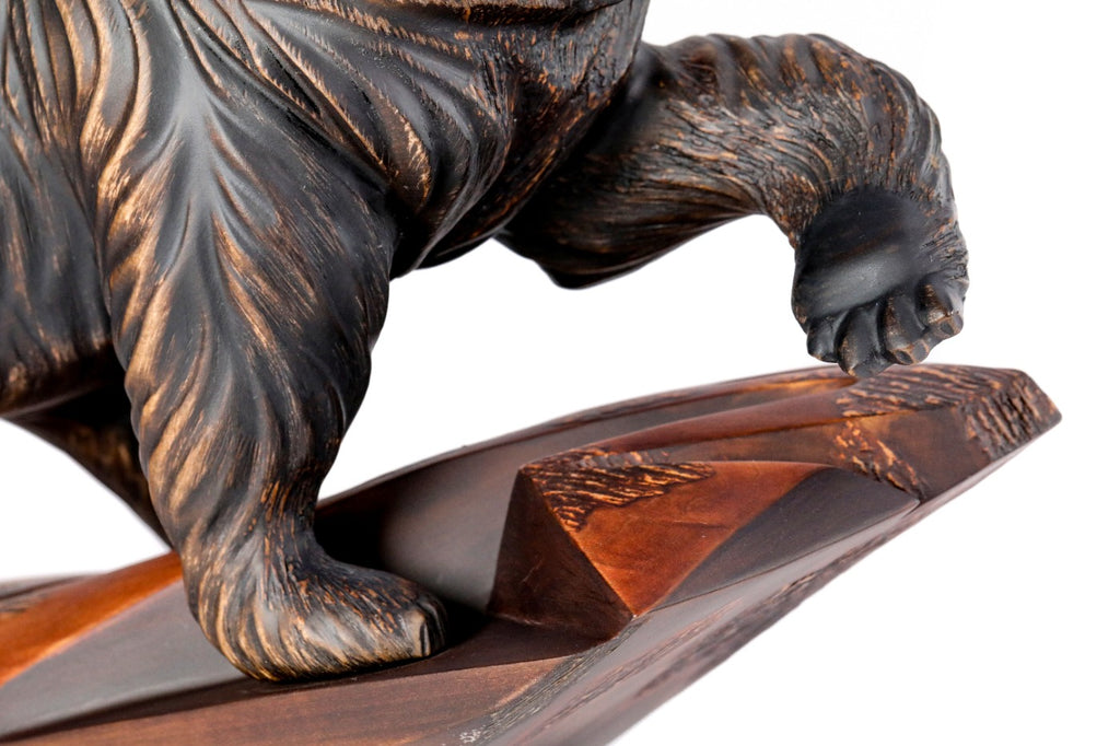 Hand-carved walnut bear sculpture — profile view