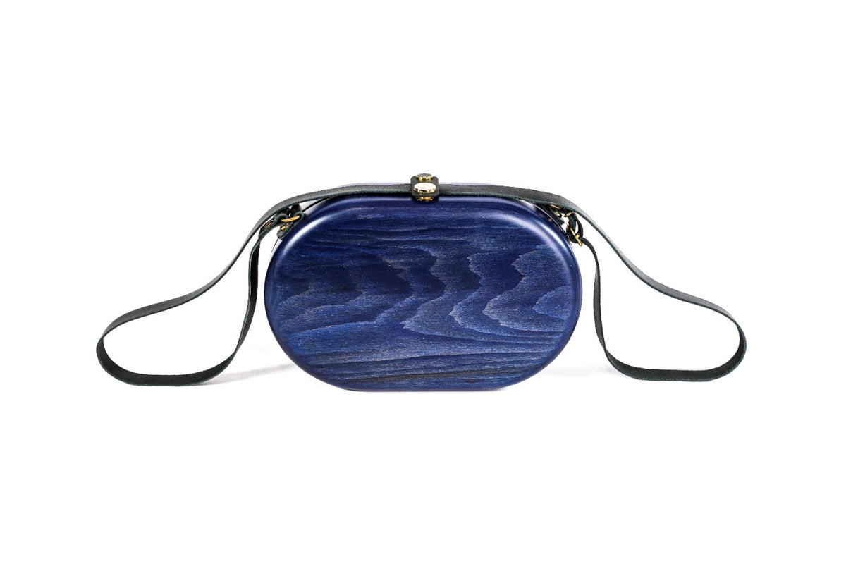 Oval wooden handbag in navy blue — detail view
