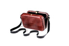 Rectangular wooden handbag in brick red — detail view