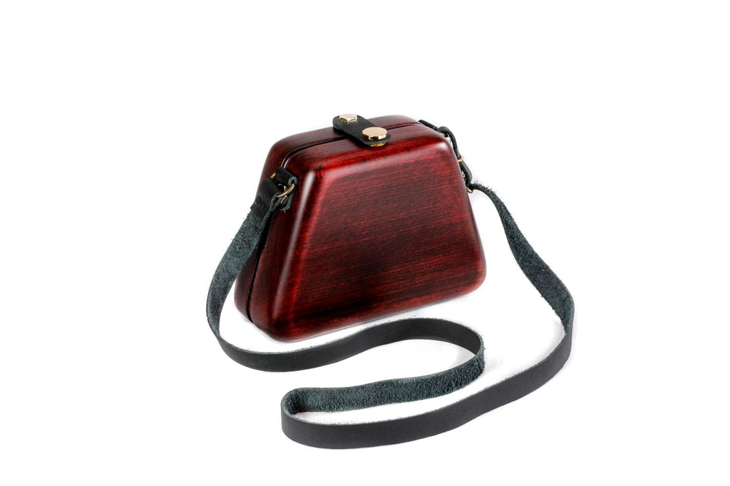 Ruby red wooden bag with leather strap — side view