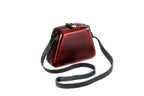 Ruby red wooden bag with leather strap — side view