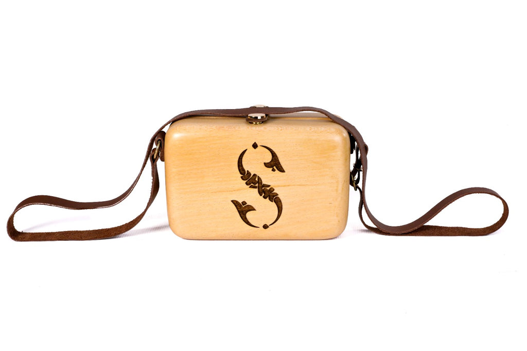 Rectangular wooden handbag with engraved ornament — detail view