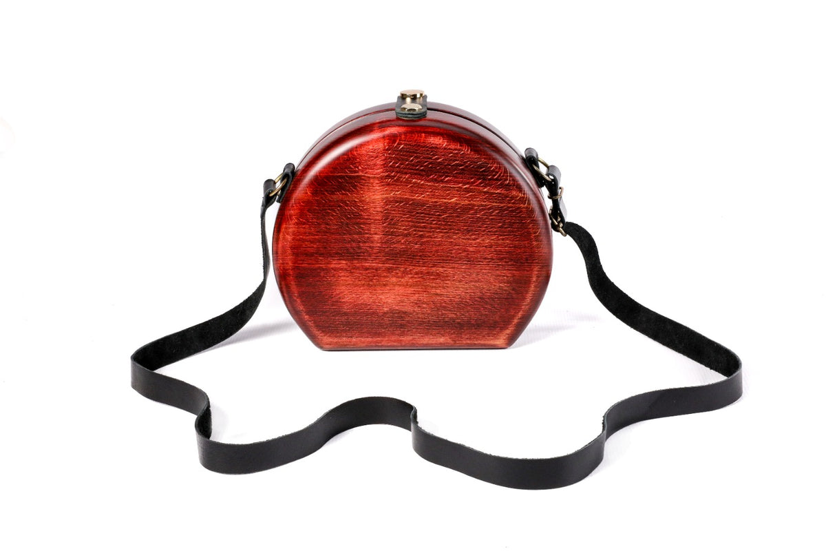 Round wooden bag with engraved ornament — angle view