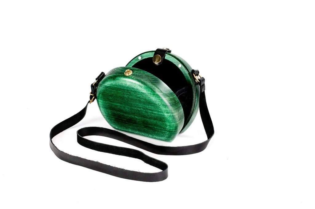 Emerald green wooden bag with leather strap — side view