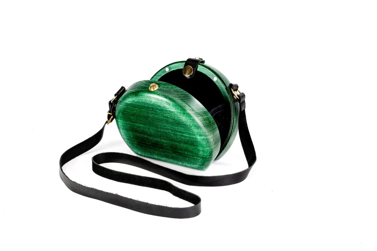 Emerald green wooden bag with leather strap — side view