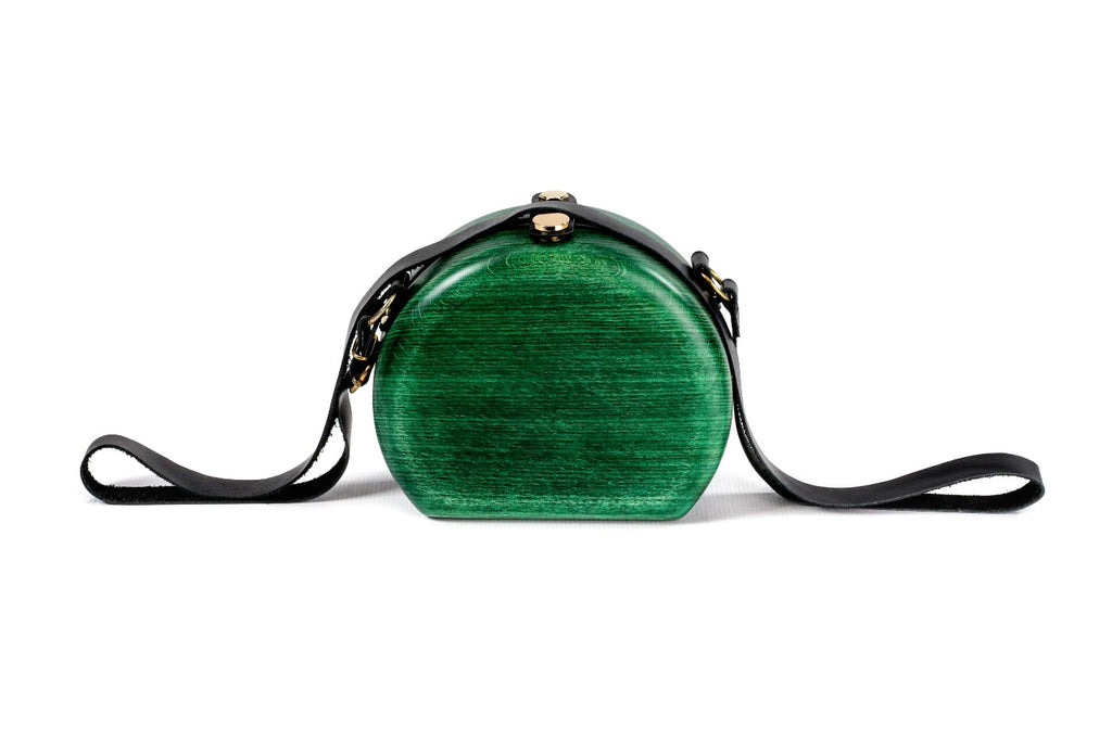 Round wooden bag in emerald green — angle view