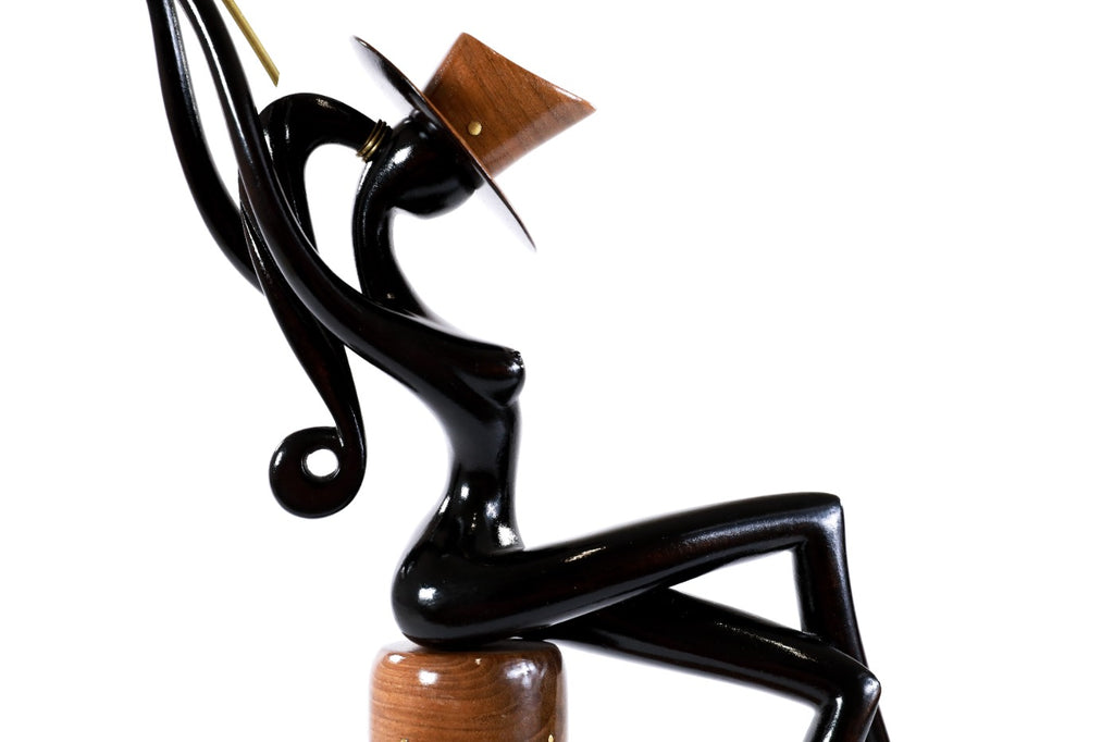 Sitting model sculpture in carved wood — side view