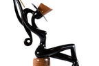Sitting model sculpture in carved wood — side view