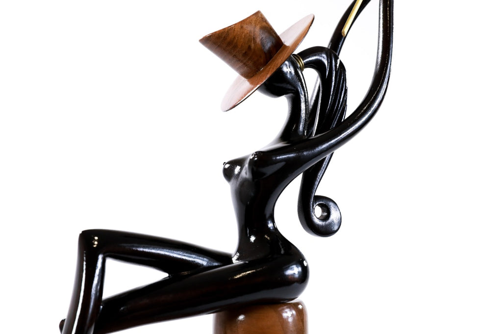 Hand-carved sitting model sculpture — close-up