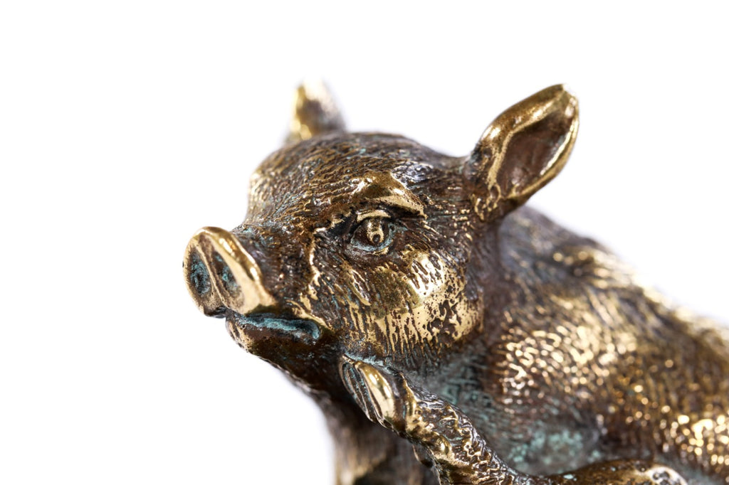 Bronze piglet sculpture — side view