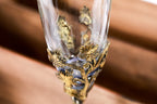 Bronze and glass cup with grape-textured bronze support — close-up