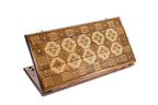 A frontal shot of the closed Lori-Pambak Carpet backgammon board showing the iconic central medallion relief carving.