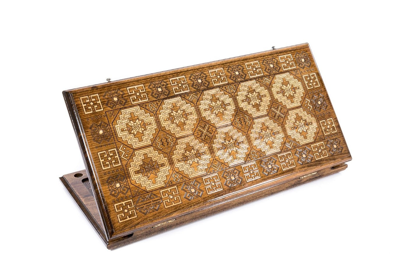 A frontal shot of the closed Lori-Pambak Carpet backgammon board showing the iconic central medallion relief carving.