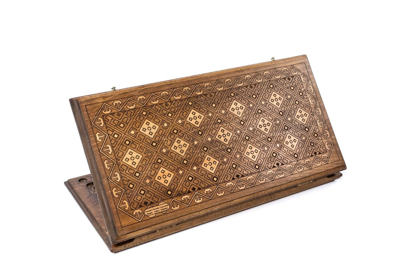A frontal shot of the closed Memling Carpet classic backgammon board showing the stepped medallion relief carving.