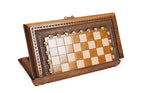 Small wooden chess board standing on edge, carved border with bronze studs