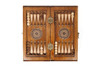 Backgammon field of the travel combo set laid flat, carved points and wheel ornaments