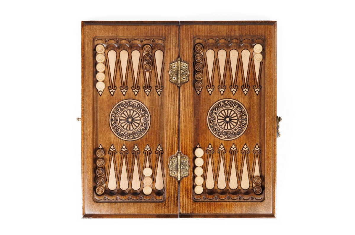 Backgammon field of the travel combo set laid flat, carved points and wheel ornaments