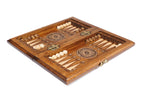 Travel chess backgammon set opened to the carved backgammon field with wheel ornaments and checkers