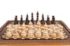 Hand-carved chess pieces in beech and walnut lined up on the portable chess board