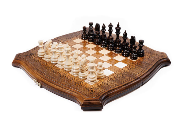 Wooden chess and backgammon set in the curved contour outline with carved scroll ornament, pieces set for play
