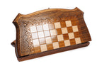 Closed wooden chess and backgammon board with curved contour outline and carved frame