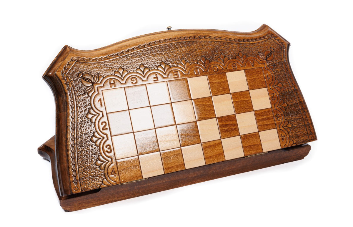Closed wooden chess and backgammon board with curved contour outline and carved frame