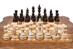 Front view of the travel chess set with hand-carved pieces and carved coordinates on the curved board