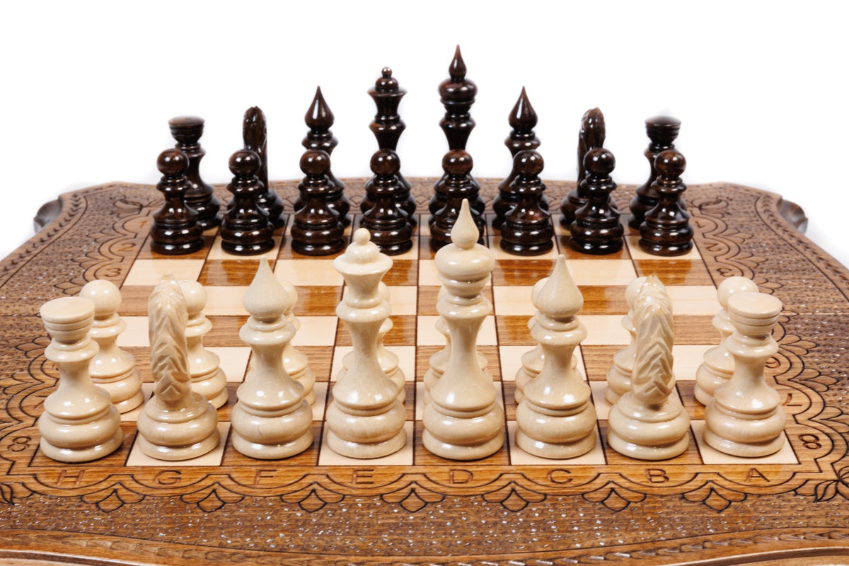 Front view of the travel chess set with hand-carved pieces and carved coordinates on the curved board