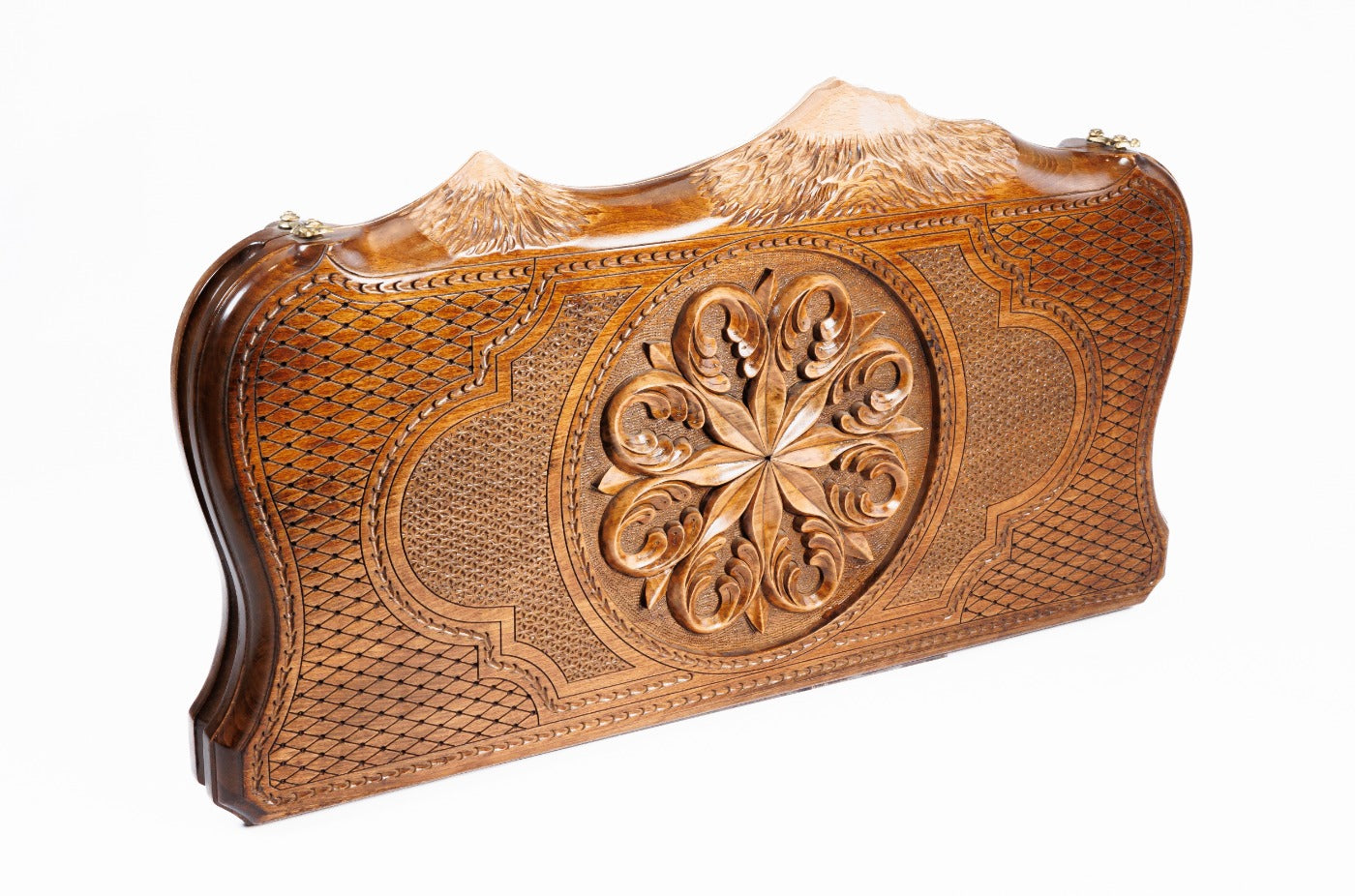 A detailed macro shot focusing on the depth of the ornamental carvings and the fine texture of the solid wood grain.