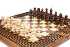 Hand-carved walnut chess board with deep braid border and resin-sealed squares, carved pieces in position