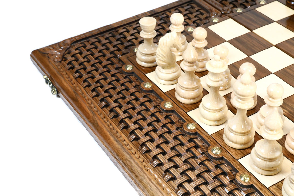 Light hand-carved chess pieces beside the open braid frame of the walnut epoxy chess board