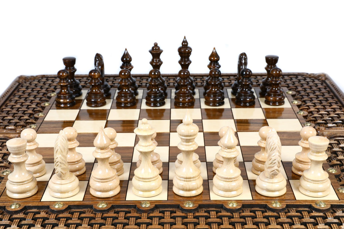 Front view of the luxury walnut chess set with all 32 hand-carved pieces on the glossy epoxy field