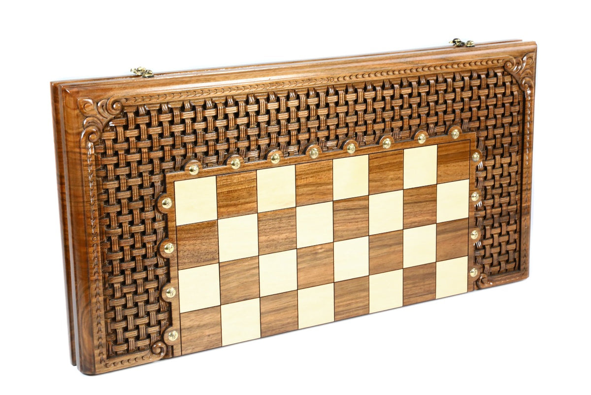 Closed walnut chess and backgammon board with braid ornament carved through around the squares